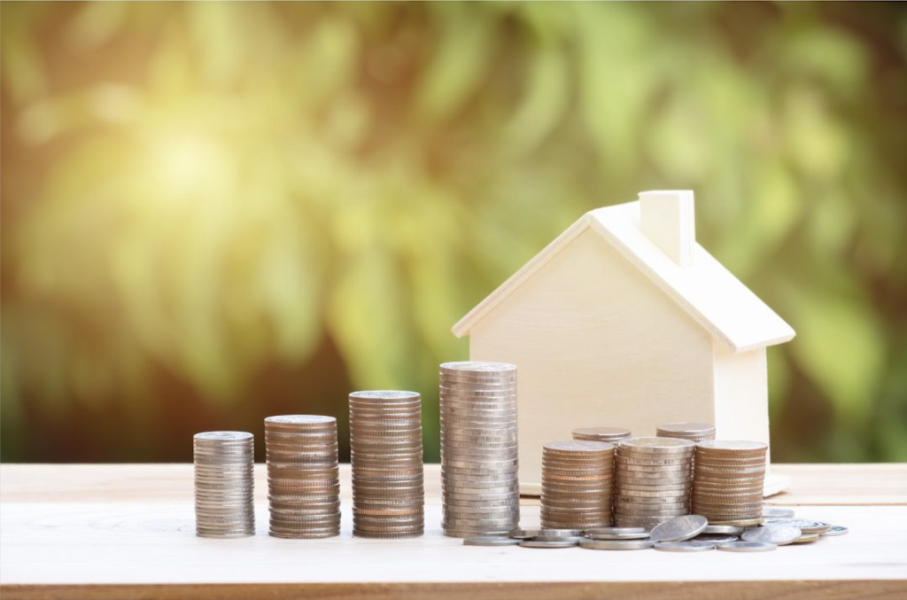 Graphic of small house next to piles of money with sun glare.